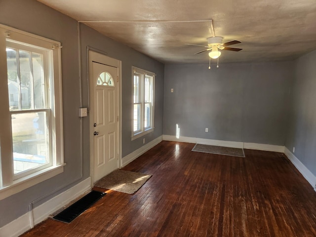 foyer entrance with ceiling fan and dark hardwood / wood-style flooring