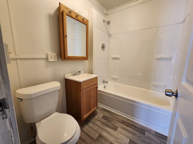 full bathroom with vanity, washtub / shower combination, crown molding, hardwood / wood-style flooring, and toilet