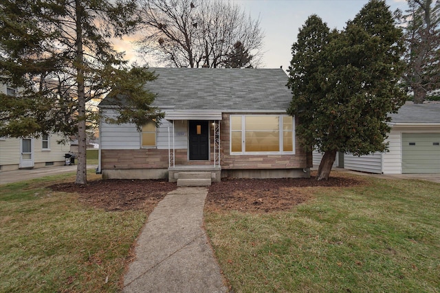 bungalow-style house with a lawn