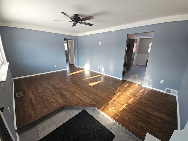 empty room with tile patterned flooring and ceiling fan