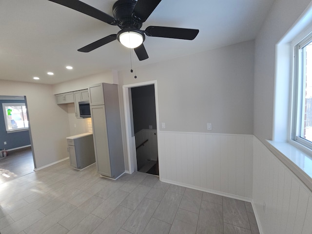 interior space with ceiling fan