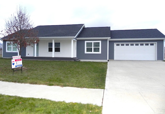 ranch-style home featuring a front lawn and a garage