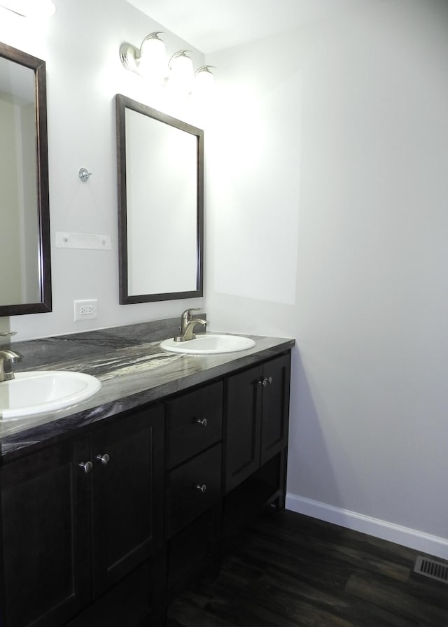 bathroom with vanity and hardwood / wood-style flooring