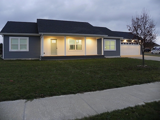 view of front of home with a garage and a front lawn