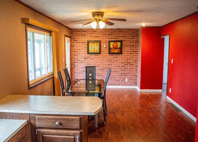 dining area with a textured ceiling, ceiling fan, dark hardwood / wood-style floors, and ornamental molding