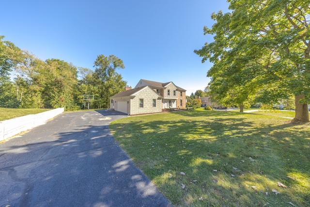 view of front of home featuring a front lawn and a garage