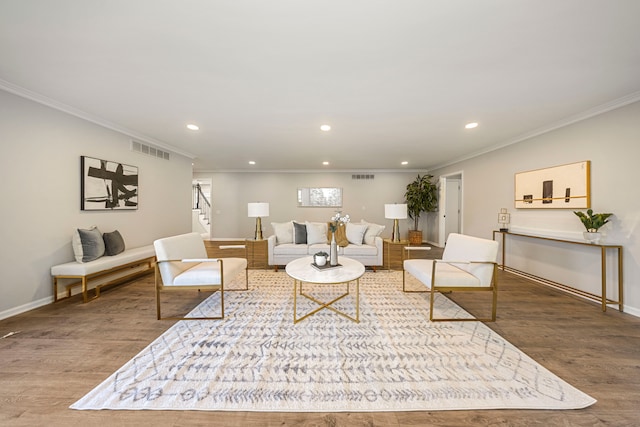 living room with wood-type flooring and ornamental molding