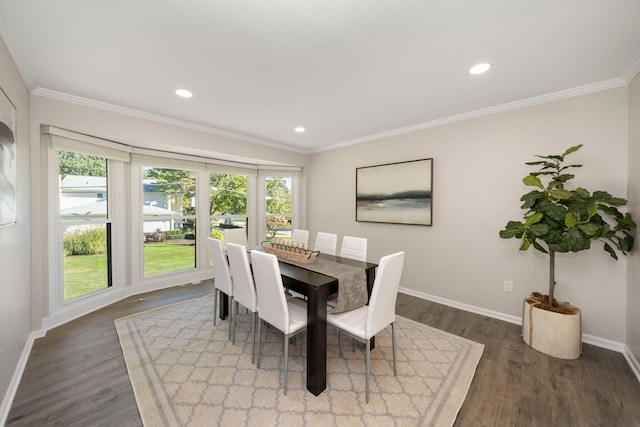 dining room with crown molding and dark hardwood / wood-style floors