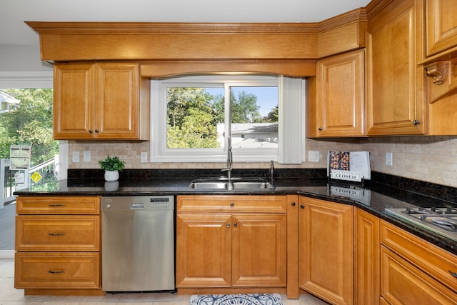 kitchen featuring dishwasher, sink, backsplash, dark stone countertops, and light tile patterned floors