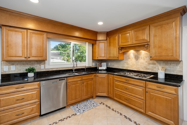 kitchen with backsplash, dark stone counters, stainless steel appliances, sink, and light tile patterned floors