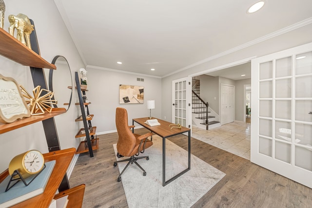 home office with french doors, ornamental molding, and hardwood / wood-style flooring