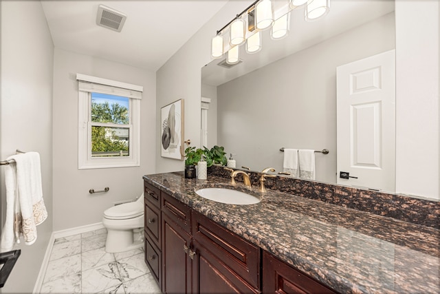 bathroom featuring vanity and toilet