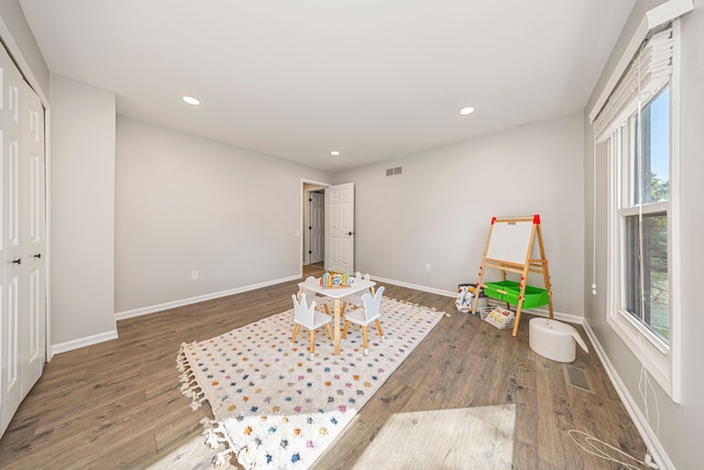 sitting room with dark wood-type flooring