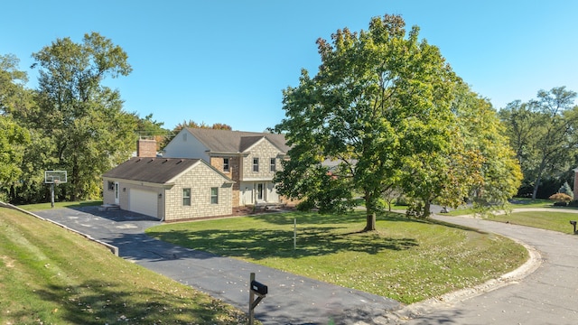 view of front of home featuring a garage and a front yard