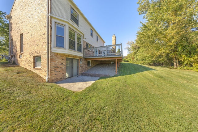 view of yard with a wooden deck and a patio area