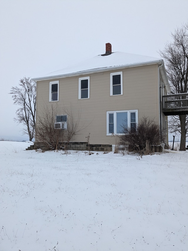 snow covered property with a wooden deck