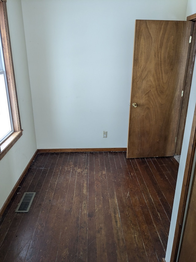 unfurnished room with dark hardwood / wood-style flooring