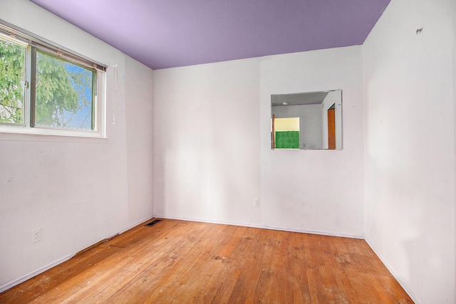 empty room with light hardwood / wood-style flooring