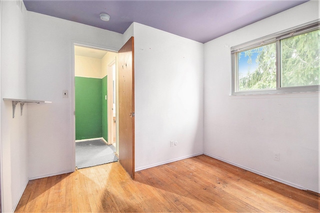 unfurnished room with light hardwood / wood-style floors