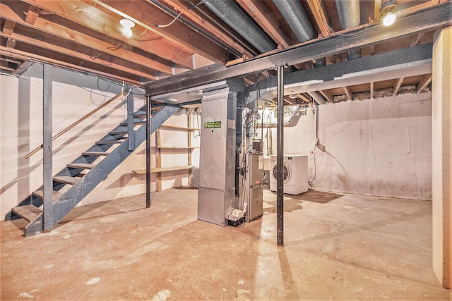 basement featuring washer and dryer and heating unit