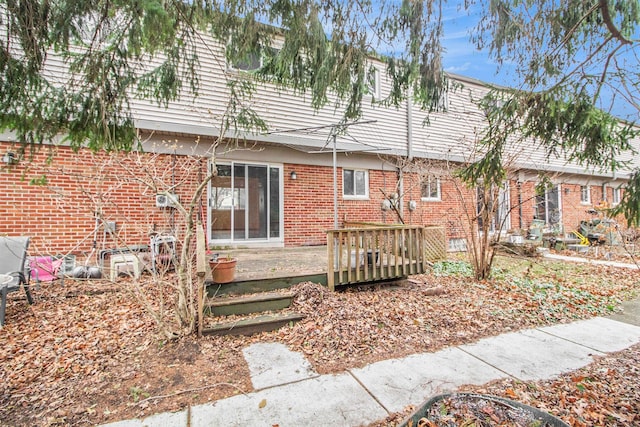 back of property with a wooden deck