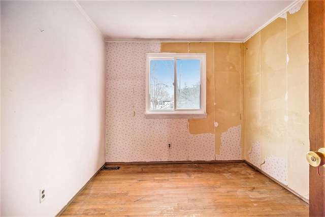 unfurnished room featuring light hardwood / wood-style floors and ornamental molding