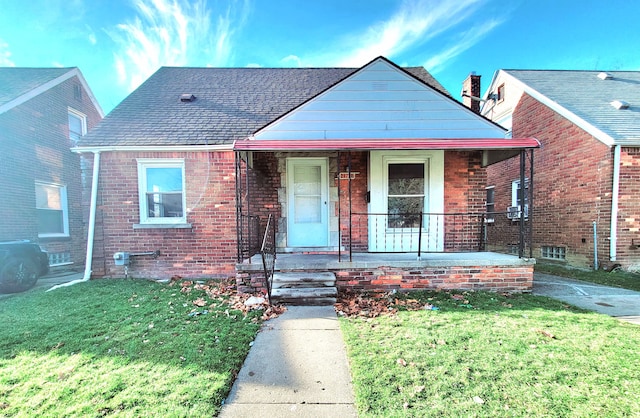 bungalow with a front yard and covered porch