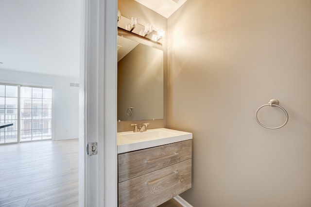 bathroom with vanity and hardwood / wood-style flooring