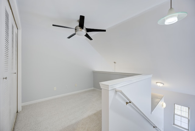 interior space with light colored carpet and lofted ceiling