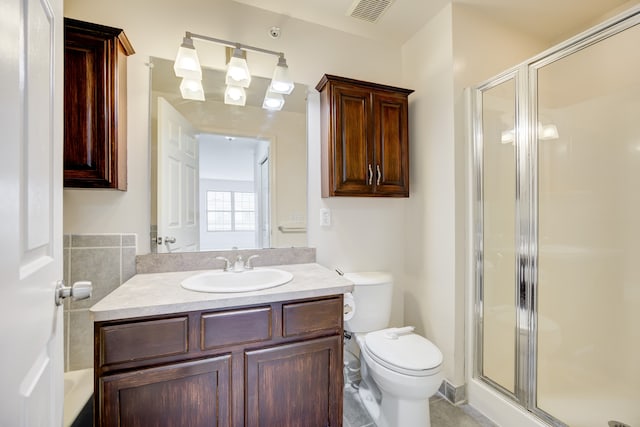 bathroom with tile patterned floors, toilet, vanity, and walk in shower