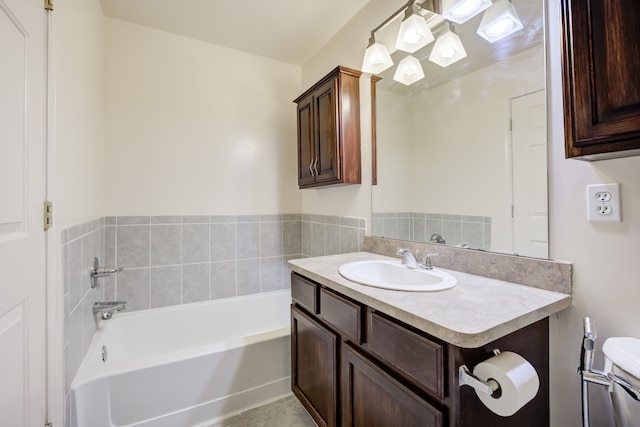 bathroom featuring tile patterned floors, vanity, and a tub to relax in