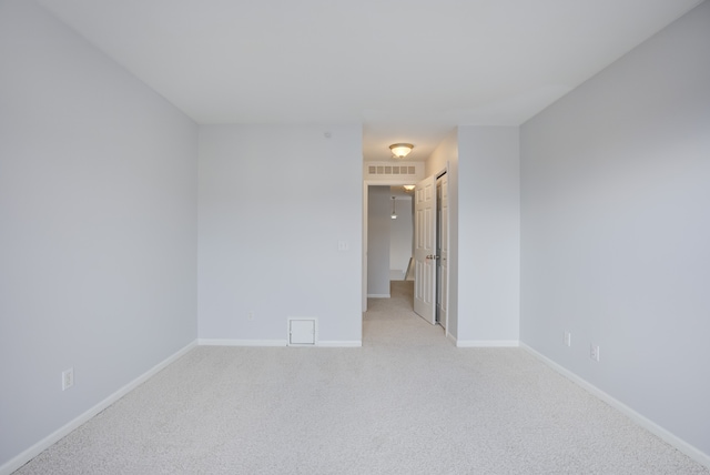 unfurnished room with light carpet