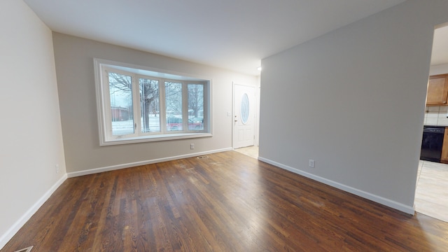 unfurnished room featuring dark hardwood / wood-style flooring