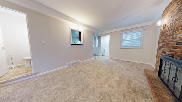 unfurnished living room featuring light colored carpet