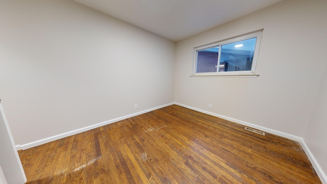 unfurnished room with hardwood / wood-style floors