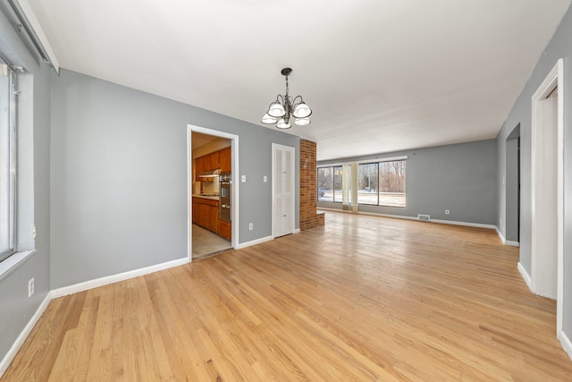 interior space featuring a notable chandelier and light hardwood / wood-style flooring