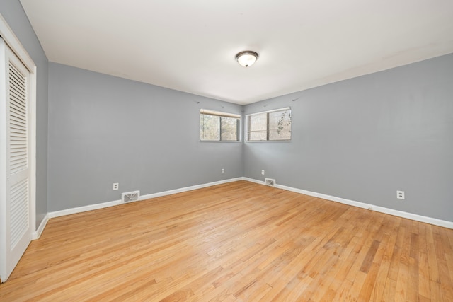 unfurnished bedroom with a closet and light wood-type flooring