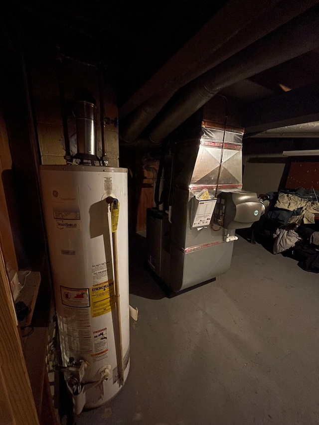 utility room with heating unit and gas water heater