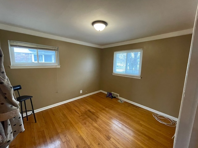 interior space featuring hardwood / wood-style floors and ornamental molding