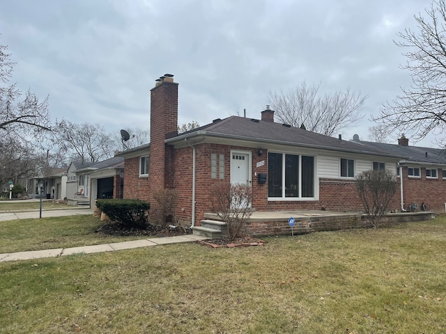 view of front of home featuring a garage and a front lawn