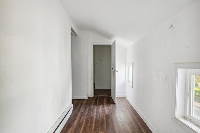 corridor with baseboard heating, dark hardwood / wood-style flooring, and lofted ceiling