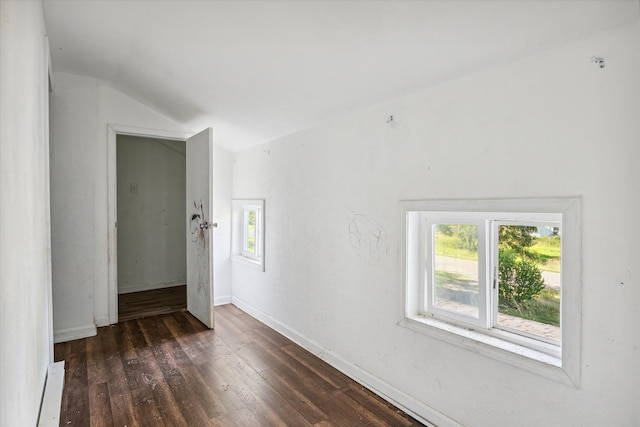 unfurnished room with lofted ceiling and dark wood-type flooring