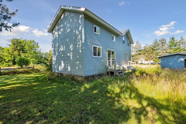 rear view of house with a yard