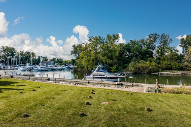 exterior space with a water view and a lawn