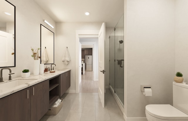 bathroom with tile patterned floors, vanity, toilet, and a shower with door