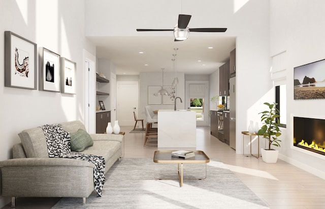 living room featuring ceiling fan and light wood-type flooring