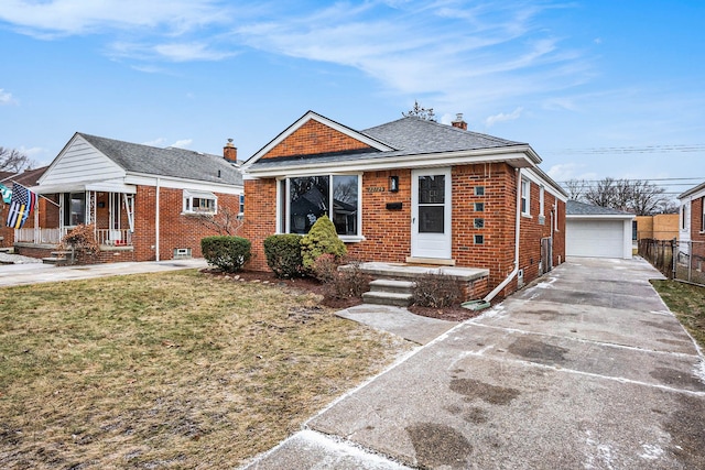 bungalow-style house featuring a front lawn, an outdoor structure, and a garage