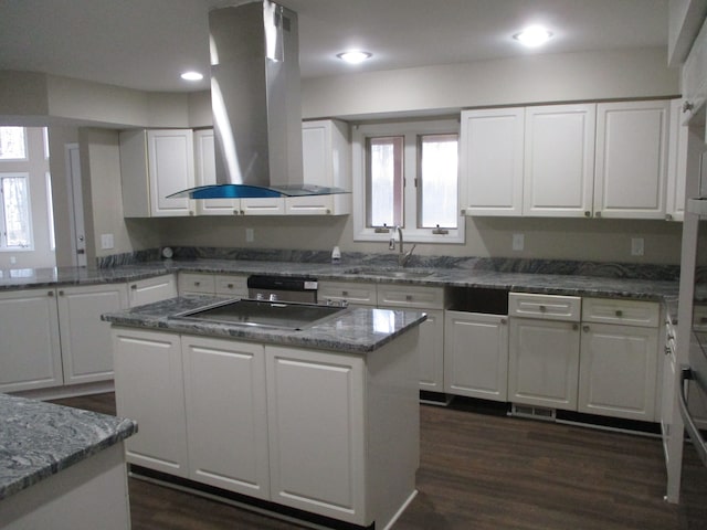 kitchen featuring island range hood, dark hardwood / wood-style flooring, white cabinets, and a kitchen island