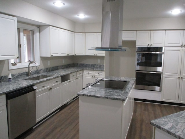 kitchen featuring island range hood, stainless steel appliances, dark wood-type flooring, white cabinets, and a kitchen island