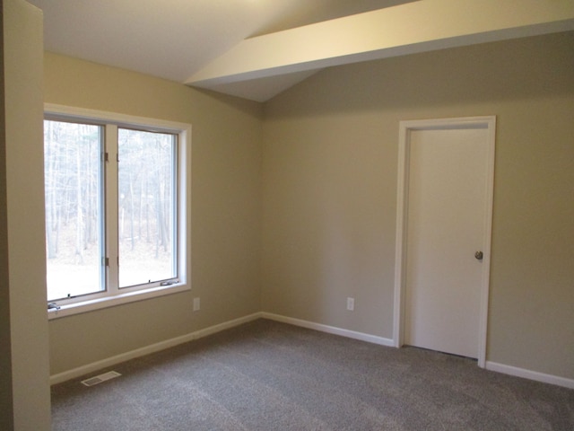 unfurnished room with plenty of natural light, carpet floors, and lofted ceiling